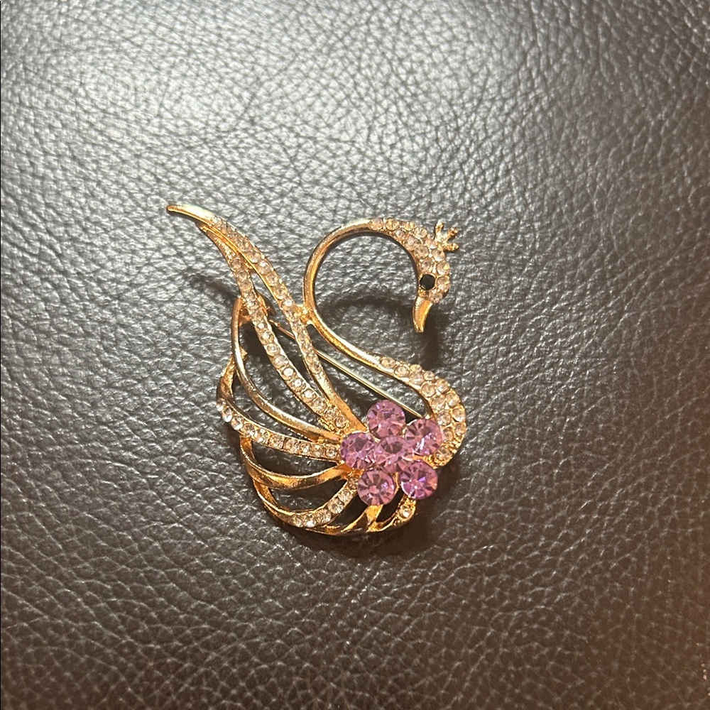 Elegant Golden Swan Brooch with Purple Accents
